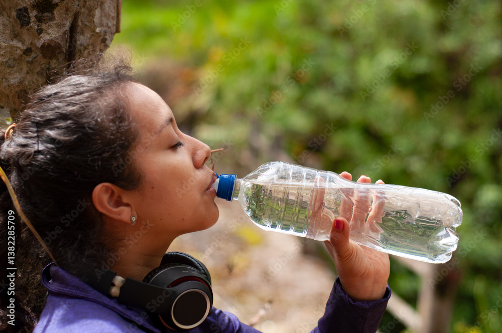 An Active Woman Enjoying Hydration While Embarking on a Thrilling Outdoor Adventure An Active Woman Enjoying Hydration While Embarking on a Thrilling Outdoor Adventure
