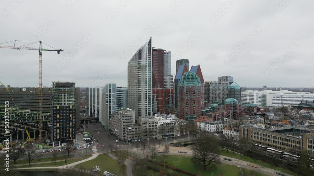 Aerial view of The Hague’s city center featuring iconic skyscrapers, modern architecture, and urban atmosphere on a cloudy day. Aerial view of The Hague’s city center featuring iconic skyscrapers, modern architecture, and urban atmosphere on a cloudy day.