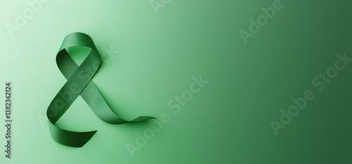 Mental Health Awareness Concept. Self Care, Positive Thinking, Happy and Optimistic Mind. a Green Ribbon lay on Green background. Table top view photo