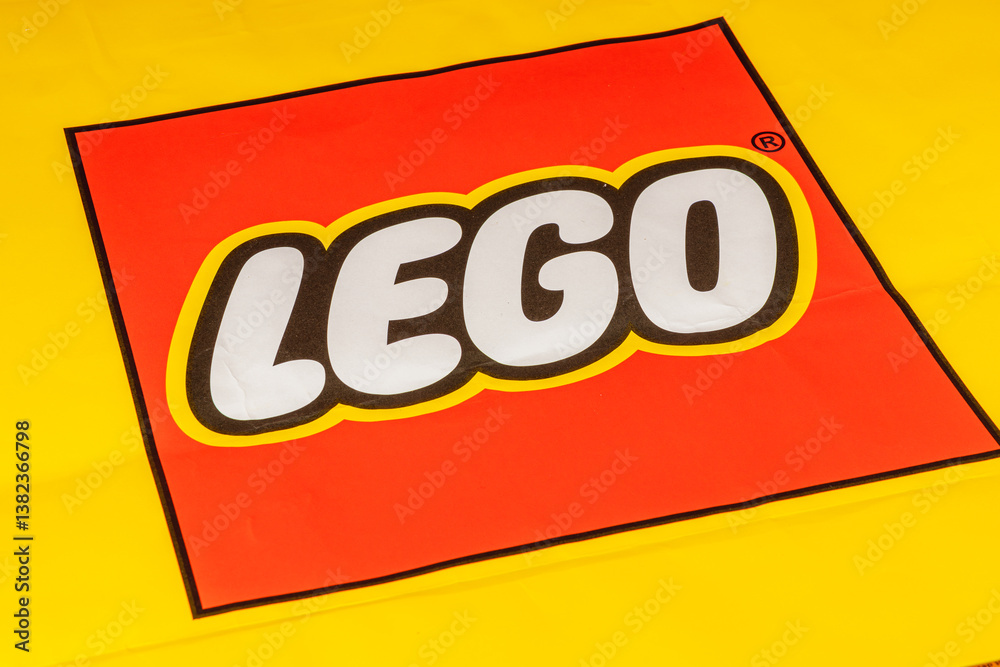Obraz premium Bright yellow background features colorful building blocks logo
