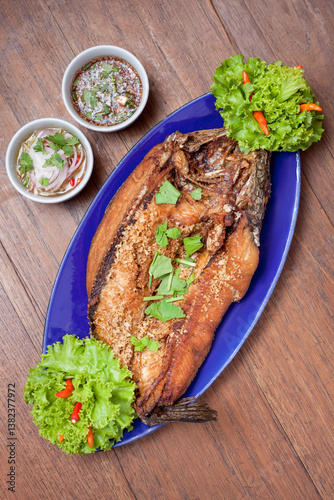 The golden fried fish with a tangy seafood sauce emphasizes the delicious traditional dish that is loved by the people of this region.