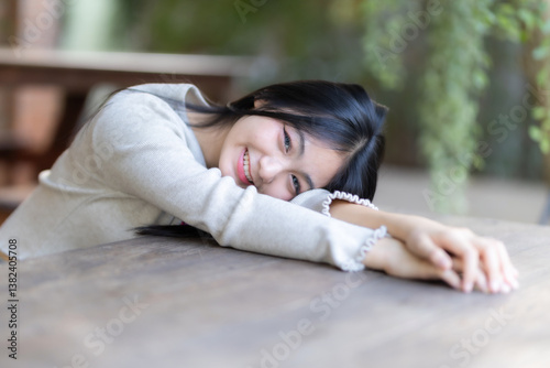 Obraz na płótnie Portrait cute smiles Asian girl putting her hands on table of attractive young teenage girl the cafe on vacation at a coffee shop in spring day w salonie