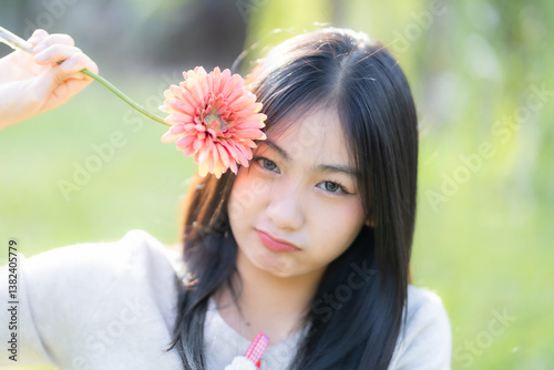 Obraz na płótnie Portrait cute smiles Asian of attractive young teenage girl Holding flowers the cafe on vacation at a coffee shop in spring day w salonie