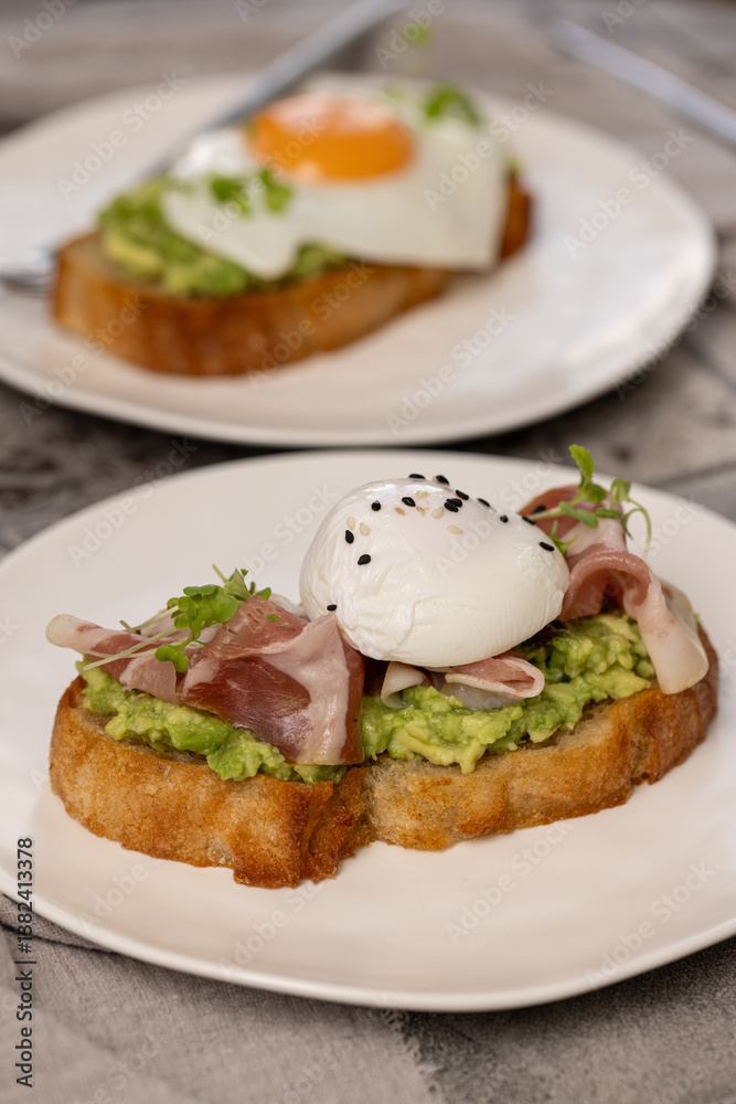 Toast with avocado, prosciutto and poached egg Toast with avocado, prosciutto and poached egg
