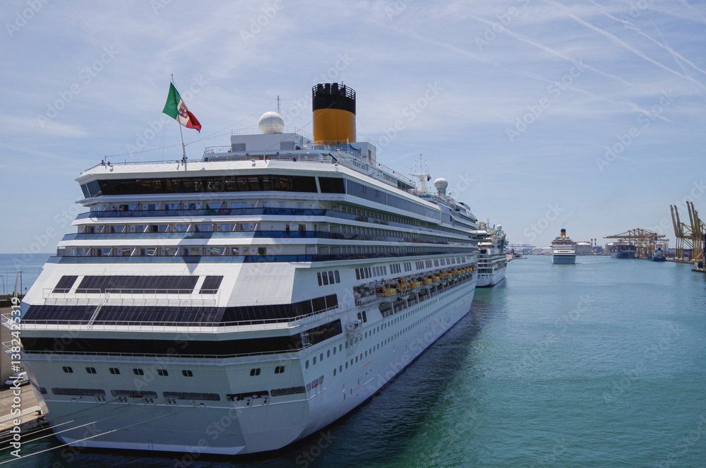 Modern family cruiseship Pacifica and other cruise ship liners in port of Barcelona, Spain on sunny summer day seen from landside during Mediterranean cruising