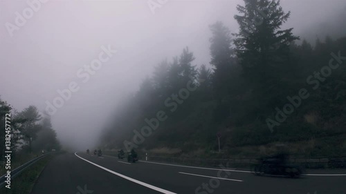 Riding motorcycles on  Schwarzwaldhochstrasse on a foggy day of autumn, in the Black Forest National Park, Germany
