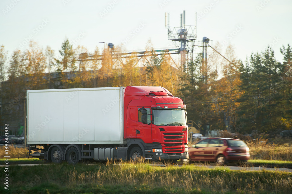 Large freight vehicle driving countryside highway