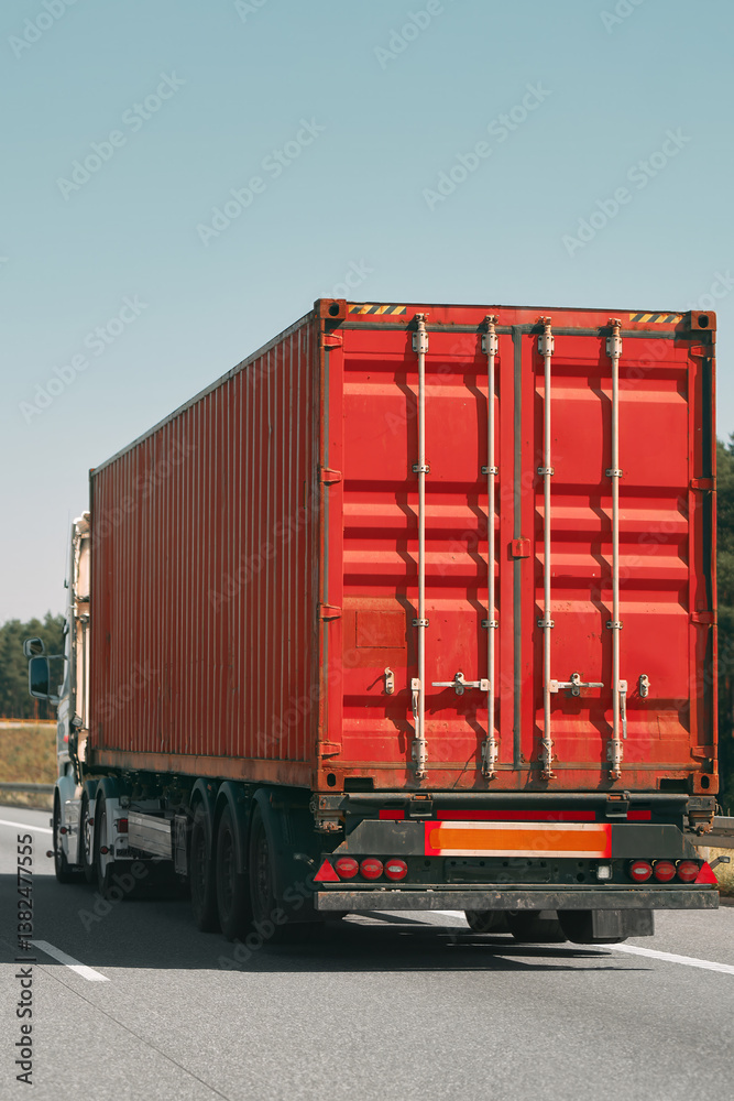 Large red container truck on highway
