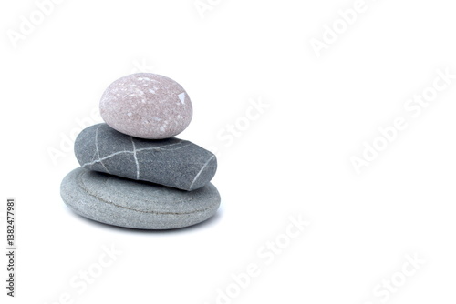Bild auf Leinwand Against a white background stands a tower made of turned sea stones