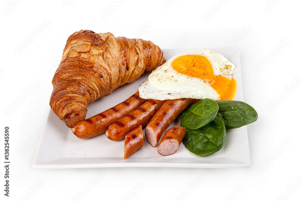 English breakfast with fried egg, sausages and croissant