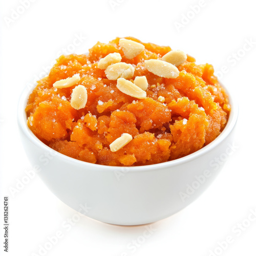 A bowl of carrot halwa, with a sweet pudding made from carrots, milk, and sugar, isolated on clean white background.