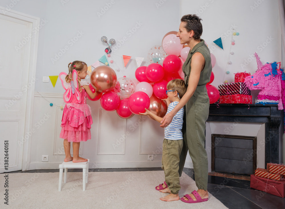 Family enjoys a vibrant, balloon-filled birthday party at home