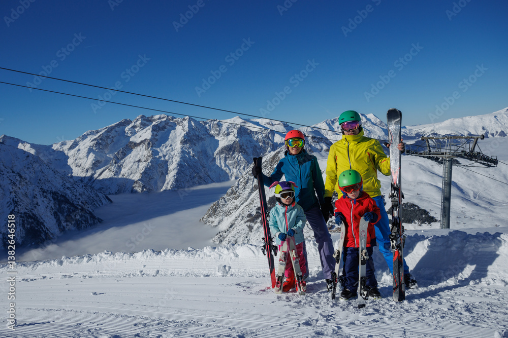 Skiing family enjoys together a sunny day in the snowy mountains
