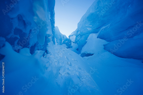Majestic natural ice canyon stretching under a vivid blue sky