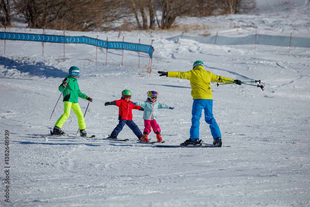 Group of beginners learning to ski under the bright blue sky