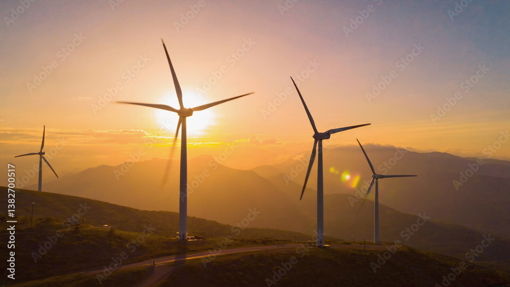 Wind turbines at sunset over hills Wind turbines at sunset over hills