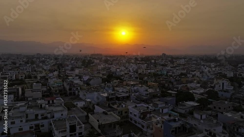 Wallpaper Mural An aerial view of the picturesque city of Dehradun in Uttarakhand, India, captured during a breathtaking sunset. The cinematic shot showcases the city's blend of urban charm and natural beauty. Torontodigital.ca