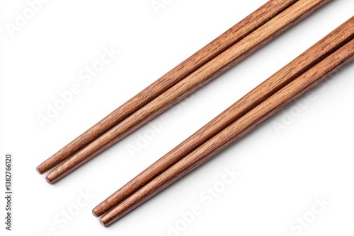 Wooden chopsticks isolated on white background. Traditional Asian eating utensils. Close up view of pair of chopsticks. Simple design. Clean and elegant. Natural material. Food tool. Bamboo