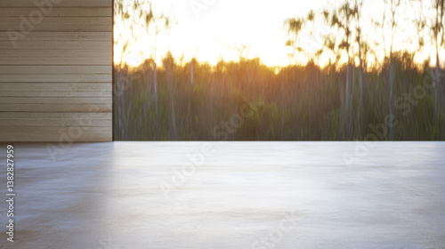 Stunning sunset view from a modern deck overlooking a serene forest landscape