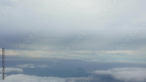 Vertical footage Cloudy skies over mountain ranges aerial view nature photography serene atmosphere captivating landscape