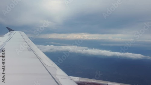 Vertical footage Airplane wing over clouds aerial view travel photography open skies tranquil environment capturing serenity and adventure