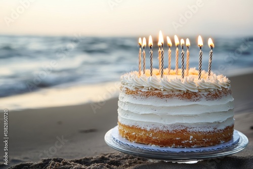 A sandy beach at sunset hosts a colorful birthday cake with candles, overlooking the ocean