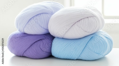 Soft pastel yarn skeins in light purple, white, and blue colors