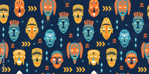 Seamless pattern of ritual masks of African ethnic tribes of various shapes on blue background.
