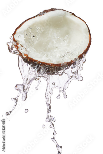 Fresh coconut water splashing from fruit. Moisture replenishing burst of water from tropical fruit.
