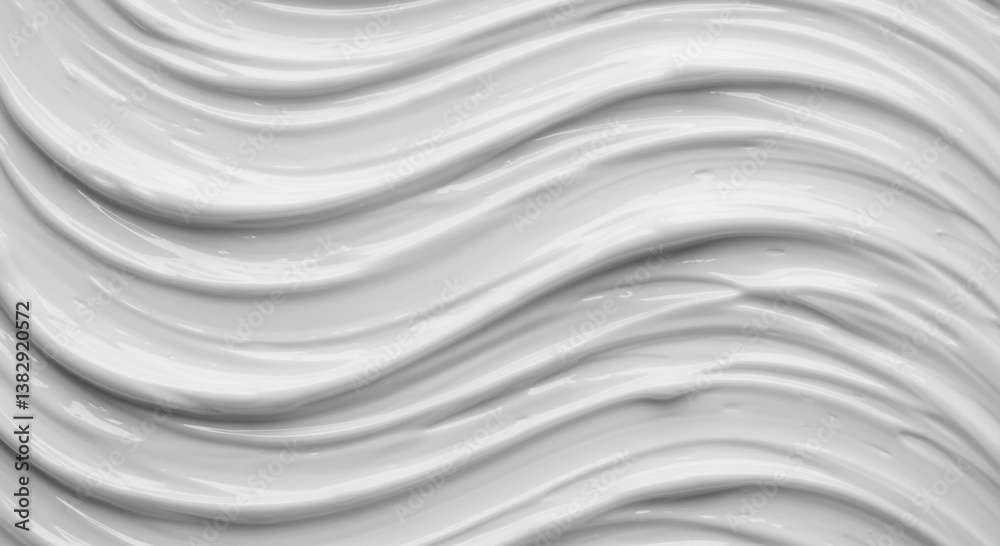 Obraz premium Close-up view of smooth, flowing white cosmetic cream texture.