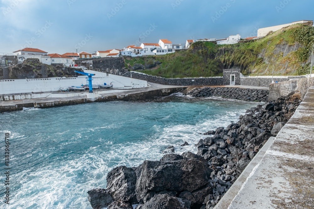 A picturesque view of a coastal village in Terceira, Azores, showcasing its charming harbor and scenic coastline