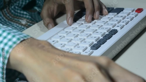 Two Asian women's hands are tapping and typing on a keyboard. They might be preparing to report information, chatting with a lover, or shopping online while connected to the internet at home or in a c