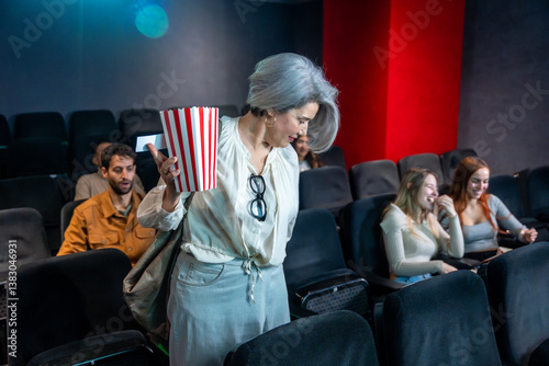 Woman searching for her seat in a crowded movie theater