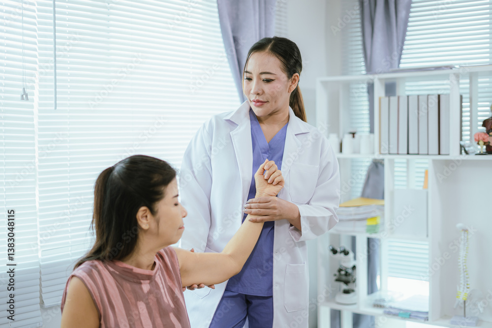 A female doctor is giving physical therapy to an elderly woman. A female doctor is giving physical therapy to an elderly woman.