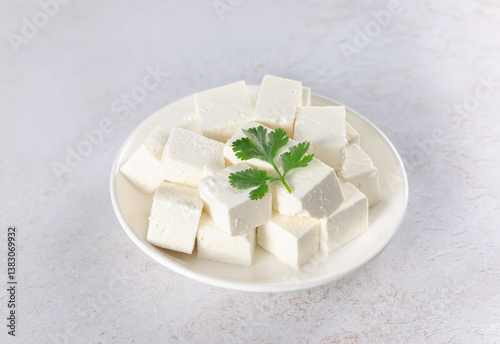 Indian paneer cheese made from fresh milk and lemon, cubes on white background. Top view.