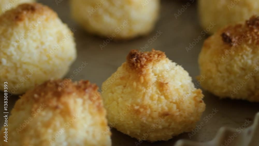 Close-up of coconut cookies on a baking tray. The golden tops of the coconut pyramids. Handmade dessert Close-up of coconut cookies on a baking tray. The golden tops of the coconut pyramids. Handmade dessert