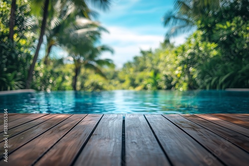 Serene Poolside View With Lush Greenery and Clear Blue Water in a Tropical Se...