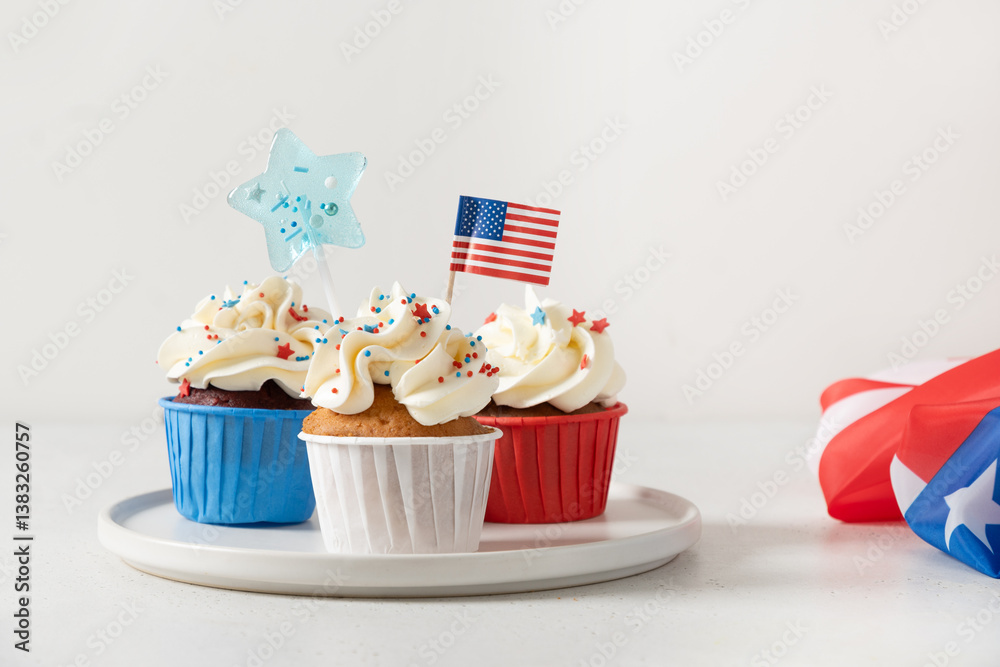 Traditional American sweet cupcakes with festive stars and USA flag on white background. Dessert for Patriotic Independence Day 4th of july.