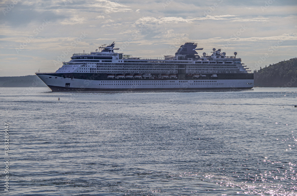 Modern Family cruiseship cruise ship liner Summit or Millennium anchored in Bar Harbor, Maine archipelago with islands, coast line and tender boats on sunny day New England Indian Summer cruising
