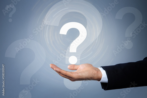 Obraz na płótnie Businessman holding virtual question mark on grey background, closeup w salonie