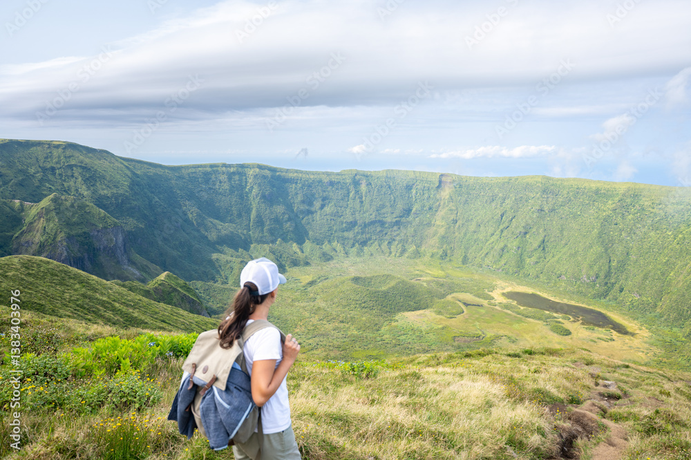 Hiker admires the Sete Cidades caldera view in Sao Miguel, Azores.