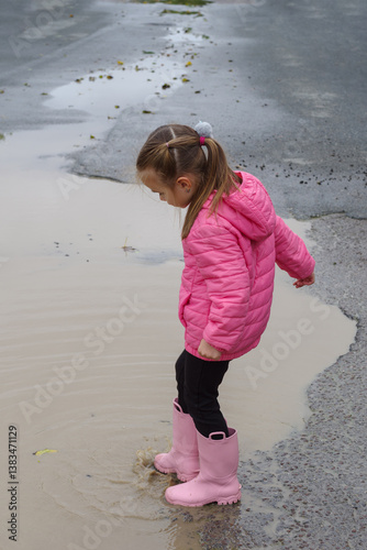 Obraz na płótnie Girl playing in a puddle of water after rain w salonie