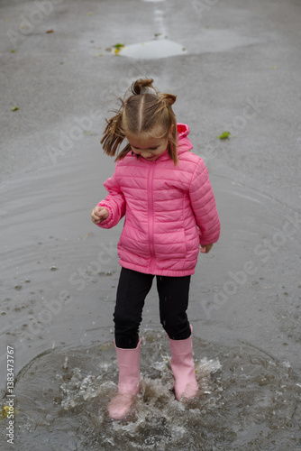Obraz na płótnie Girl playing in a puddle of water after rain w salonie
