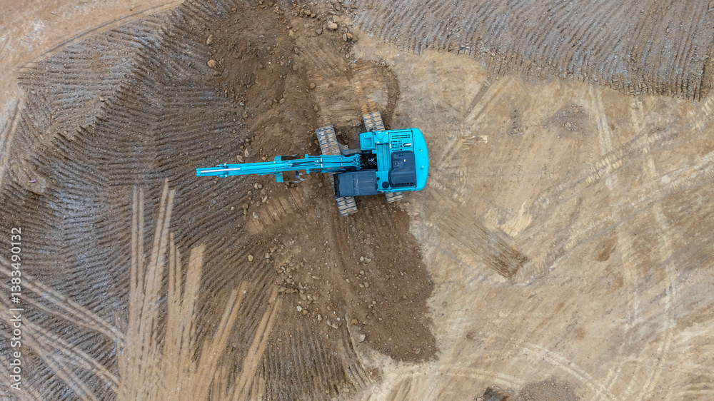 Excavator digs move earth at construction site, Excavator working and digging at construction site, Crawler excavator digger earth gravel on transportation truck at construction site, Top view