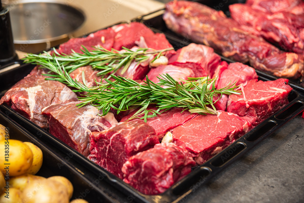 Raw Beef Cuts with Fresh Rosemary for Grilling. Raw Beef Cuts with Fresh Rosemary for Grilling.