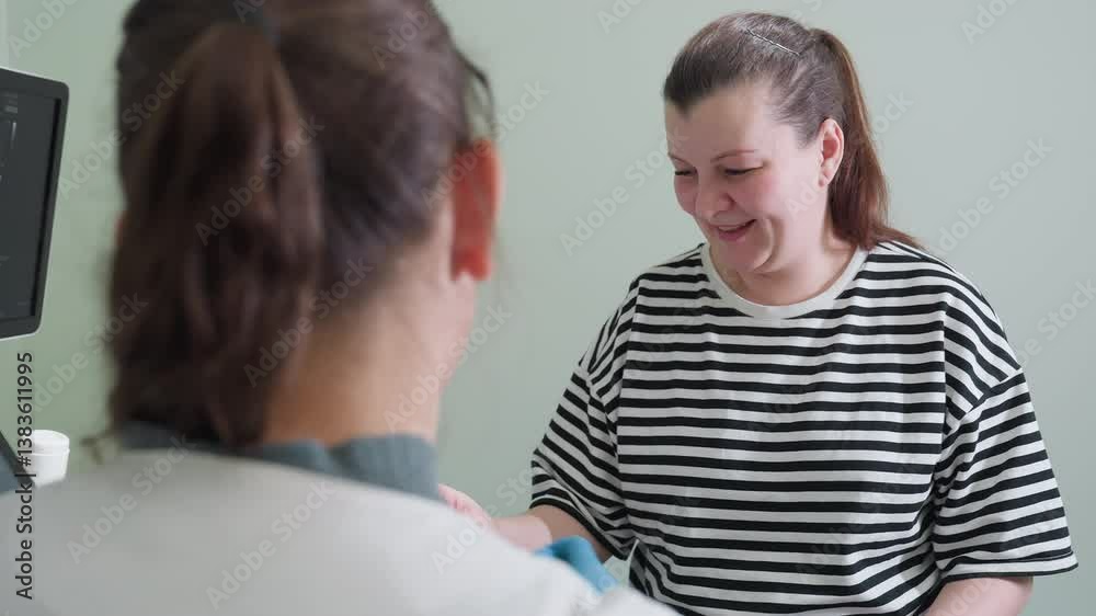 Medical practitioner interpreting scan result to joyful, smiling patient in consultation. Patient smiles heartfully as doctor explains results, sharing positive moment of excitement and understanding Medical practitioner interpreting scan result to joyful, smiling patient in consultation. Patient smiles heartfully as doctor explains results, sharing positive moment of excitement and understanding
