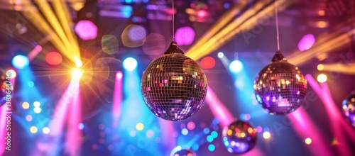 Vibrant nightclub scene with glittering disco balls hanging under a dynamic display of colorful purple and yellow stage lights