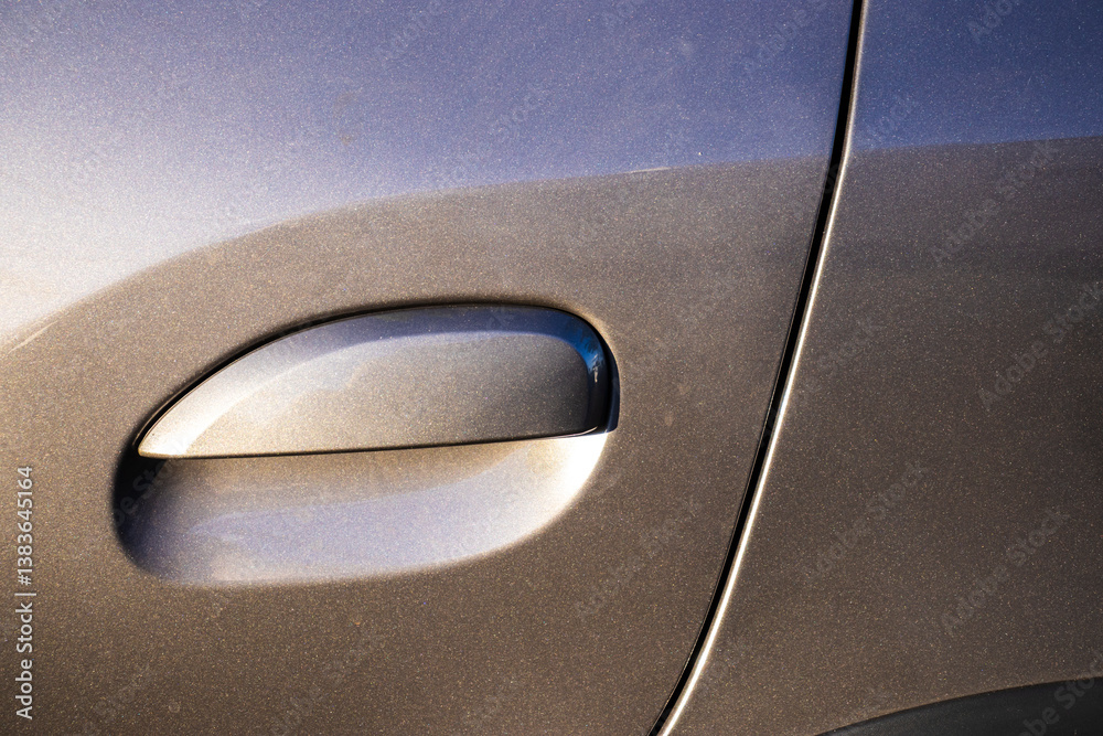 Close-up of car door handle with metallic gray-blue paint in Brazil. Showcases modern automotive design, ideal for automotive, design, and technology theme