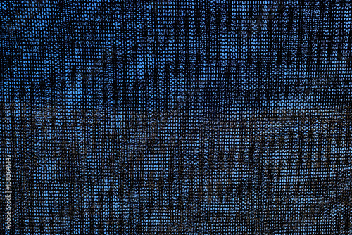 Close-up of black shading mesh against a blue sky. Commonly used in agriculture to protect crops from sunlight