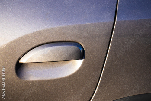 Obraz na płótnie Close-up of car door handle with metallic gray-blue paint in Brazil. Showcases modern automotive design, ideal for automotive, design, and technology theme w salonie